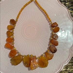 Necklace with amber colored stones all way around